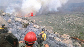 A photo taken by the Granite Mountain Hotshots on June 30 shows their position on a ridge, with a red arrow indicating the original location of their lookout. The crew's lookout was the only team member to survive the fire. Chris MacKenzie/Granite Mountain Hotshots