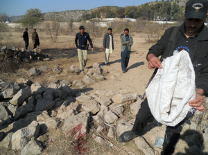 Pakistani security personnel examine the site of a suicide bombing in the Ibrahimzai area of Hangu, Pakistan, on Monday. The bombing killed 15-year-old Aitizaz Hasan, who prevented the bomber from attacking a school. Basit Shah/AFP/Getty Images