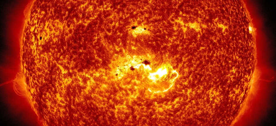 Coming At You: An image created by NASA combines two pictures from its Solar Dynamics Observatory. One shows the location of a large sunspot; the other shows Tuesday's massive solar flare. NASA/SDO