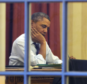 President Obama, working at his desk Monday night on the eve of his 2014 State of the Union address. Jacquelyn Martin/AP