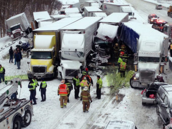 Emergency crews work at the scene of a massive pileup Thursday involving more than 40 vehicles, many of them semitrailers, along Interstate 94. AP