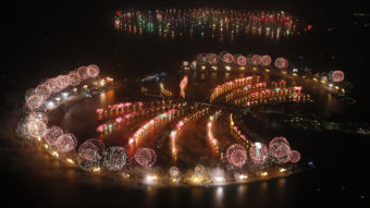 Fireworks explode over Palm Jumeirah in Dubai on Jan. 1, 2014, to celebrate the new year. Dubai's glittering fireworks display that lasted around six minutes spanned over 100 kilometres (60 miles) of the Dubai coast, which boasts an archipelago of man-made islands. Karim Sahib/AFP/Getty Images