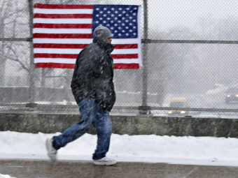 A man walks across a bridge in Trenton, N.J., on Saturday. More cold weather is headed his way. Mel Evans/AP