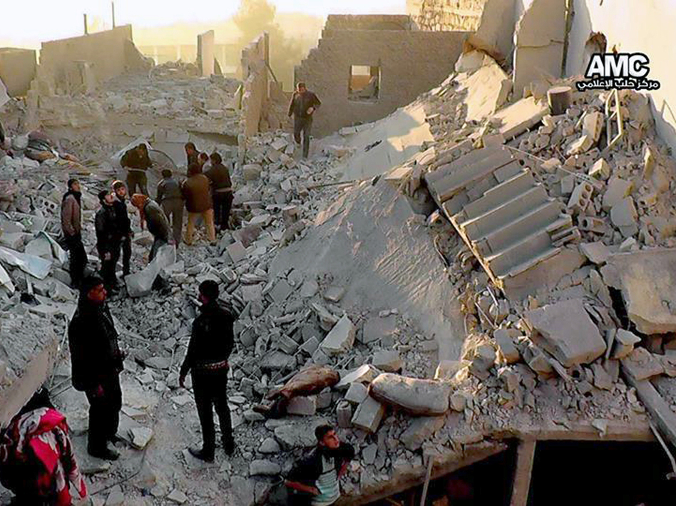 Syrians inspect the rubble of destroyed buildings following a government airstrike in Aleppo, in this image provided Monday that was taken by a citizen journalist. AP