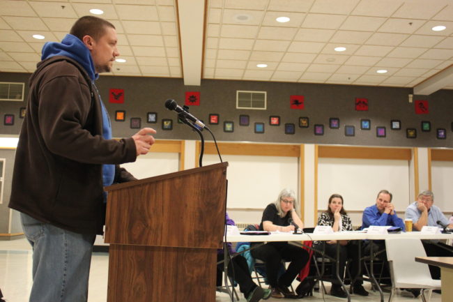 Teacher Adam Berkey tells the budget committee that money for a new language arts curriculum should go to teachers directly to buy their own new books for the classroom. (Photo by Lisa Phu/KTOO)