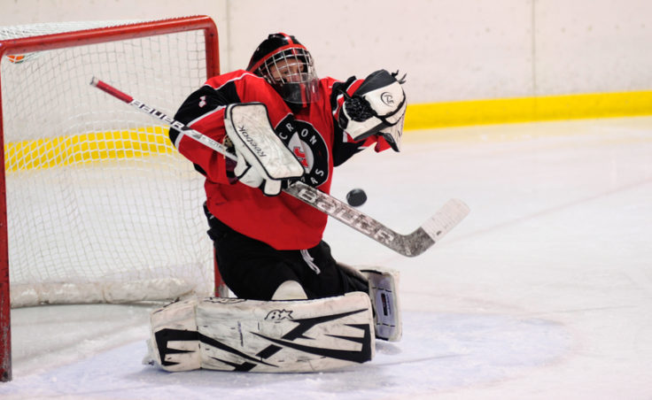 Juneau goalie Liam McDermott gets a blocker on a shot taken by a Bartlett skater during the weekend series at Treadwell Ice Arena.