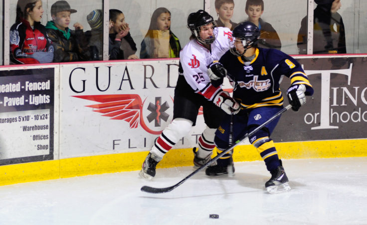 Ryan Liebelt fends off a checking attempt by Bartlett’s Kyle Sun during the weekend series at Treadwell Ice Arena.