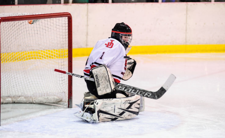Juneau goaltender Liam McDermott deflects a shot to his right en route to a shut out versus Monroe Catholic.