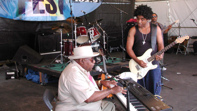 Chris Thomas King plays on the House of Blues stage with his father, Tabby Thomas, in 2001, at the New Orleans Jazz and Heritage Festival. Douglas Mason/AP