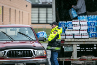 Members of the Nitro Volunteer Fire Department distribute water to local residents on Saturday. Michael Switzer/AP