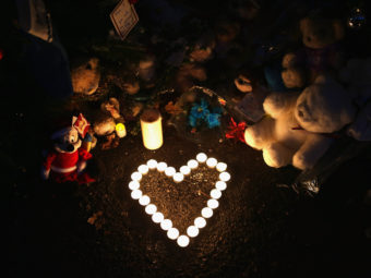 Newtown, Conn., Dec. 20, 2012: Stuffed animals and a candle arrangement at a streetside memorial for the 20 children and six adults killed at Sandy Hook Elementary School. John Moore/Getty Images