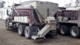 A salt truck is outfitted with side tanks that spray liquid cheese brine on the roads of Polk County, Wisconsin. Highway officials say the approach is more effective than using salt alone and reduces waste. Emily Norby/Polk County Highway Dept.