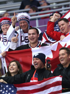 U.S. and Canadian fans attend the women's hockey gold medal game in Sochi Thursday. A recent Gallup poll finds that Americans see Canada in the most favorable light, compared to other countries. (Bruce Bennett/Getty Images)