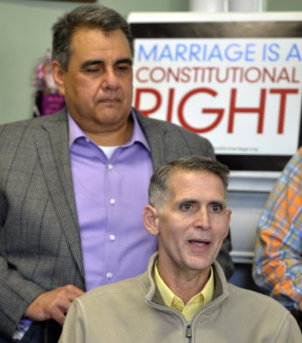 Greg Bourke, front, and his partner Michael Deleon speak to reporters following the announcement from U.S. District Judge John G. Heyburn striking down part of Kentucky's same-sex marriage ban. Timothy D. Easley/AP