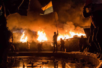 Anti-government protesters guard the perimeter of Independence Square, known as Maidan, on Tuesday in Kiev, Ukraine. Police in Ukraine's capital attacked an opposition camp that's been the center of the massive anti-government protests that began last November. Brendan Hoffman/Getty Images