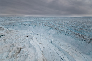 Massive sections of ice (center front) have broken away from the Jakobshavn glacier into the sea. There's enough water stored in Greenland's glaciers to raise the sea level by 20 feet. Ian Joughin/Science/AAAS