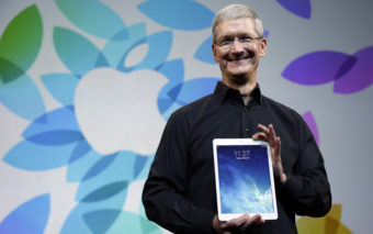Apple CEO Tim Cook introduced the iPad Air in October 2013. The company says it is publicizing the names of suppliers that are still sourcing minerals from conflict regions. Marcio Jose Sanchez/AP