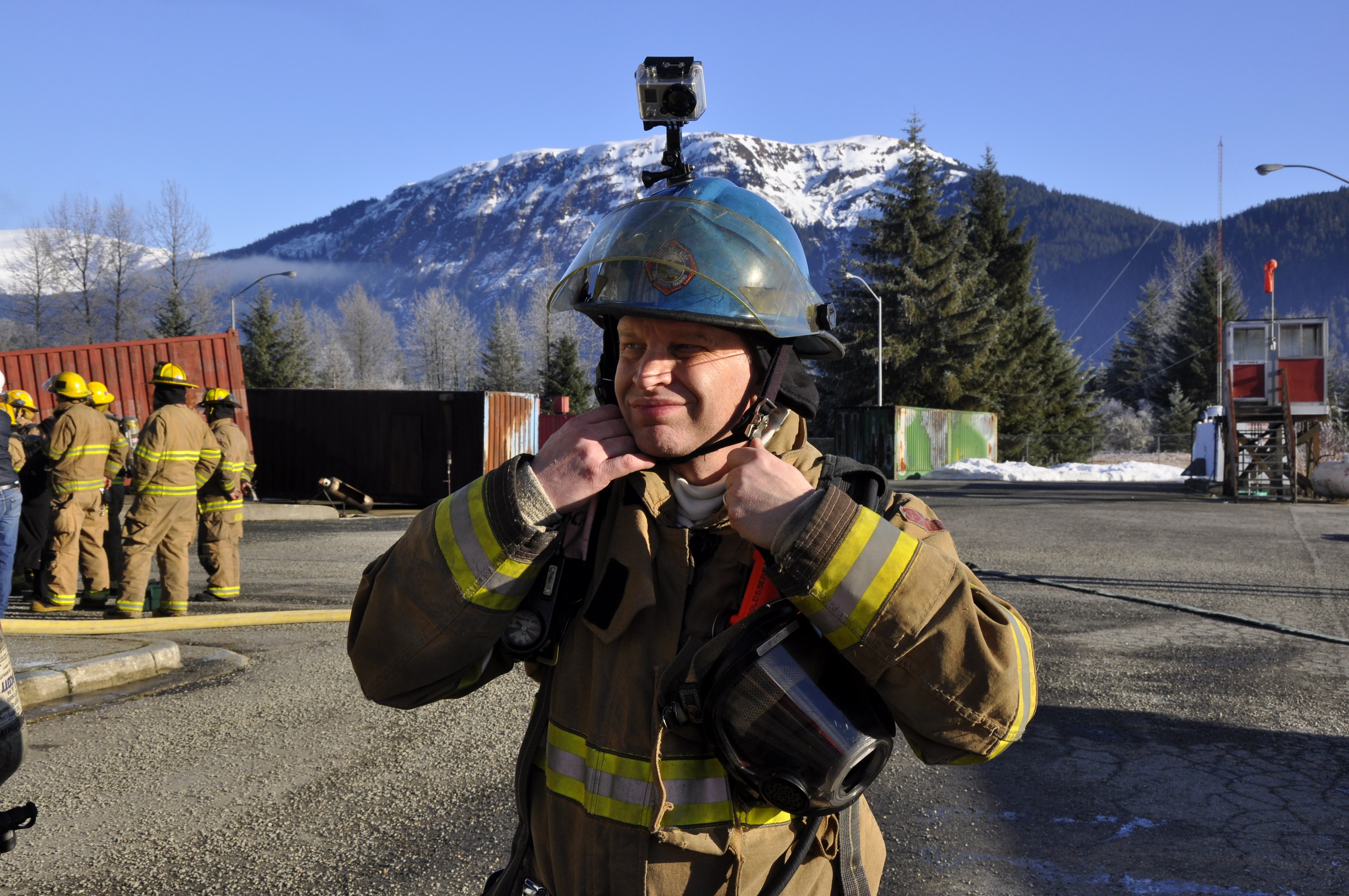 KTOO's Matt Miller adjusts his hood and helmet during a recent Fire Ops 101 training exercise in Juneau. (Photo by Annie Bartholomew/KTOO)