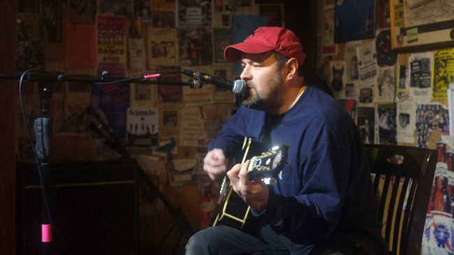 A guy plays guitar at Open Mic in Juneau, Alaska