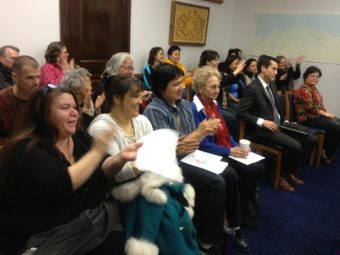 The Barnes Committee Room erupts in applause after an Alaska House committee advanced legislation that would make 20 Alaska Native languages official state languages on Feb. 18, 2014.