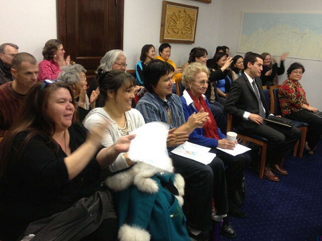 The Barnes Committee Room erupts in applause after an Alaska House committee advanced legislation that would make 20 Alaska Native languages official state languages on on Feb. 18, 2014. 