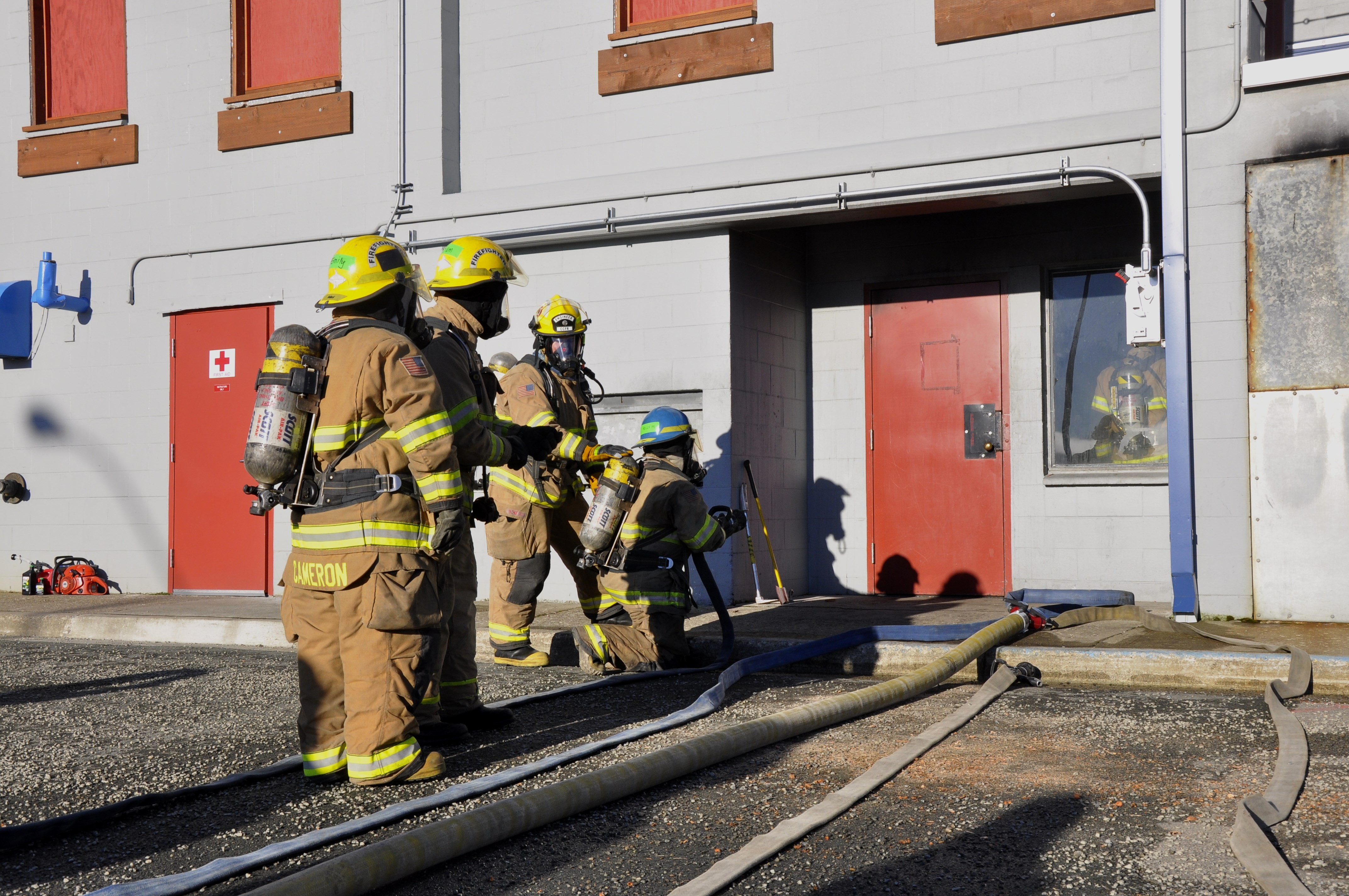 Participants get ready to enter a smoky room to put out a controlled fire at Hagevig Fire Training Center. Photo by Annie Bartholomew/KTOO