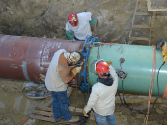 Pipefitters work on construction of the Keystone XL Pipeline's southern portion outside Tulsa, Okla., last January. PR Newswire