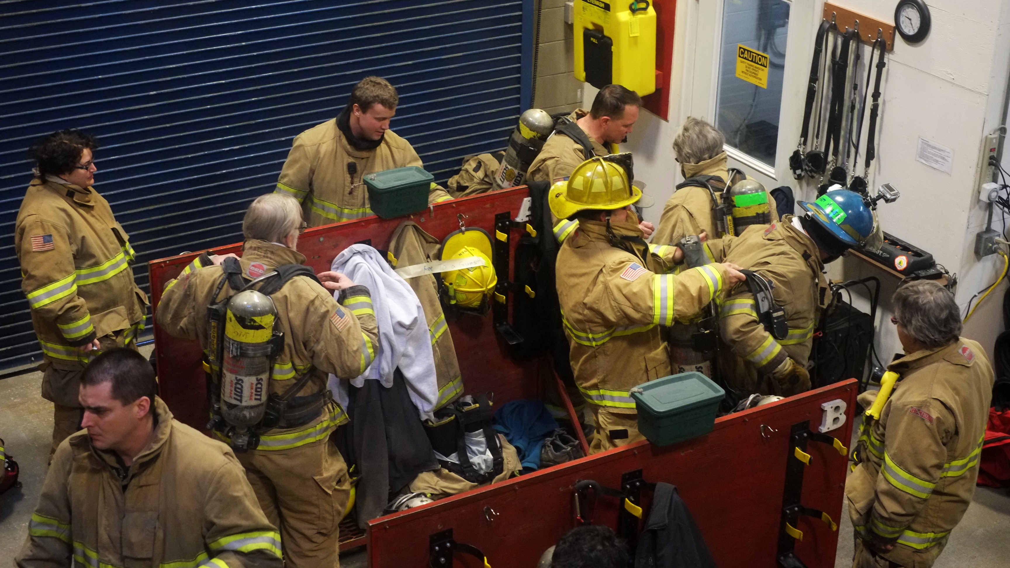 Participants and firefighters put on equipment for the first time at the safety training at Hagevig Fire Training Center. Photo by Annie Bartholomew/KTOO