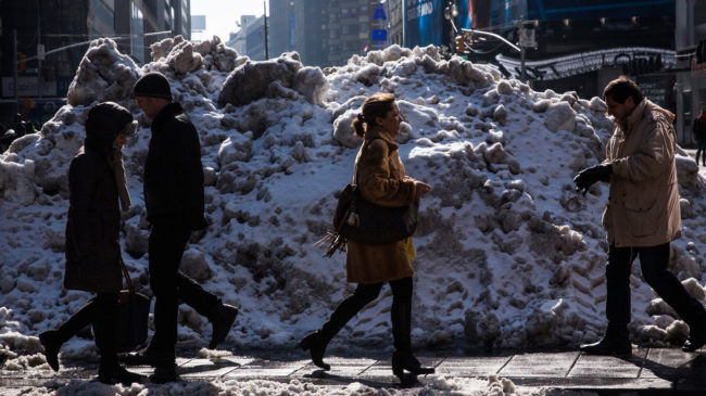 It will melt eventually: People walk past a pile of dirty snow in New York City's Times Square. Andrew Burton/Getty Images