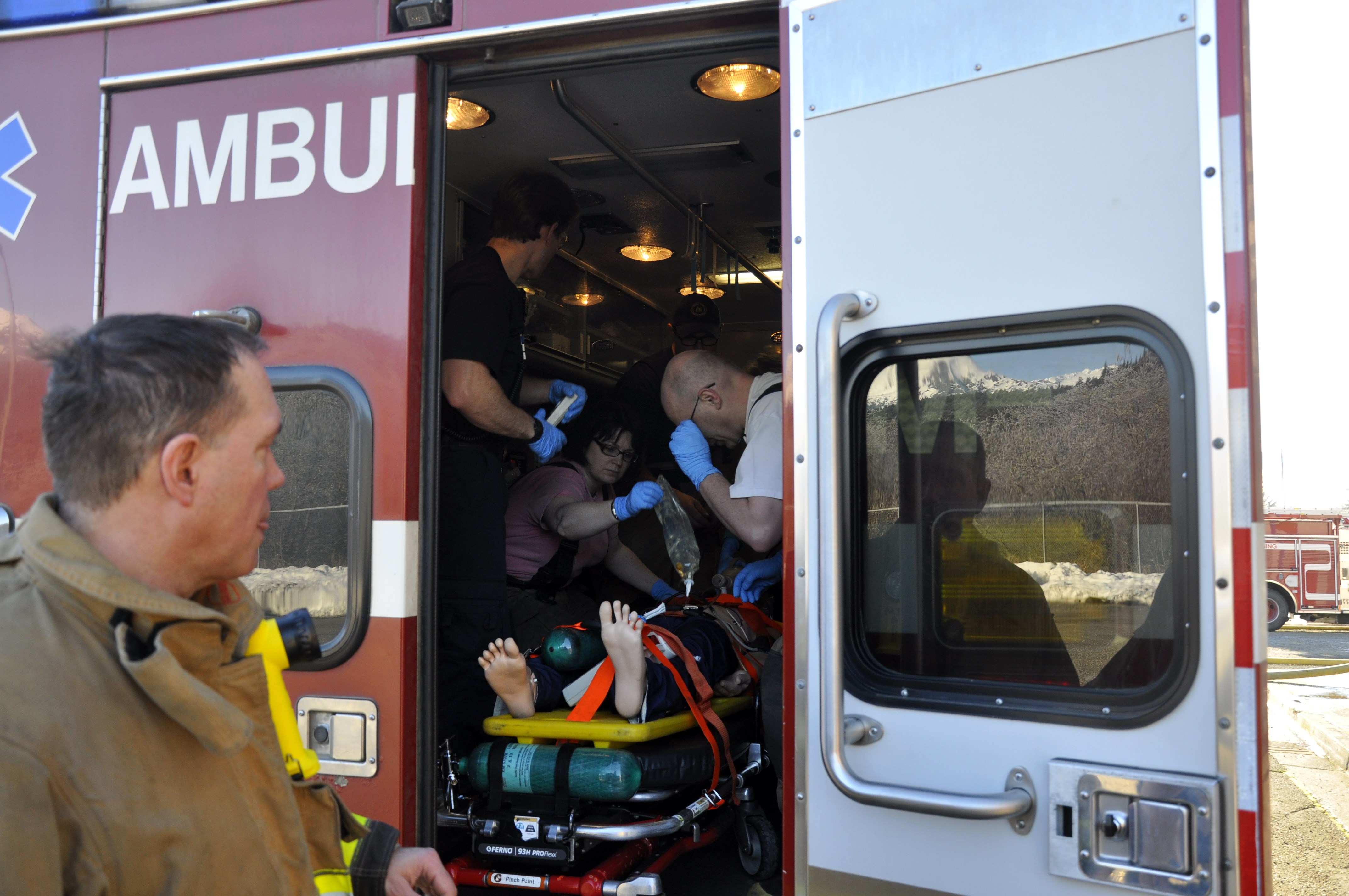Participants load the dummy into the ambulance where they will perform CPR on the patient while the vehicle is in motion. (Photo by Annie Bartholomew/KTOO)