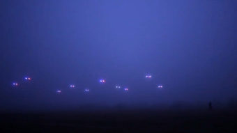 An image from a video by the COLLMOT Robotic Research Project shows a group of drones flying autonomously across a field. COLLMOT Robotic Research Project