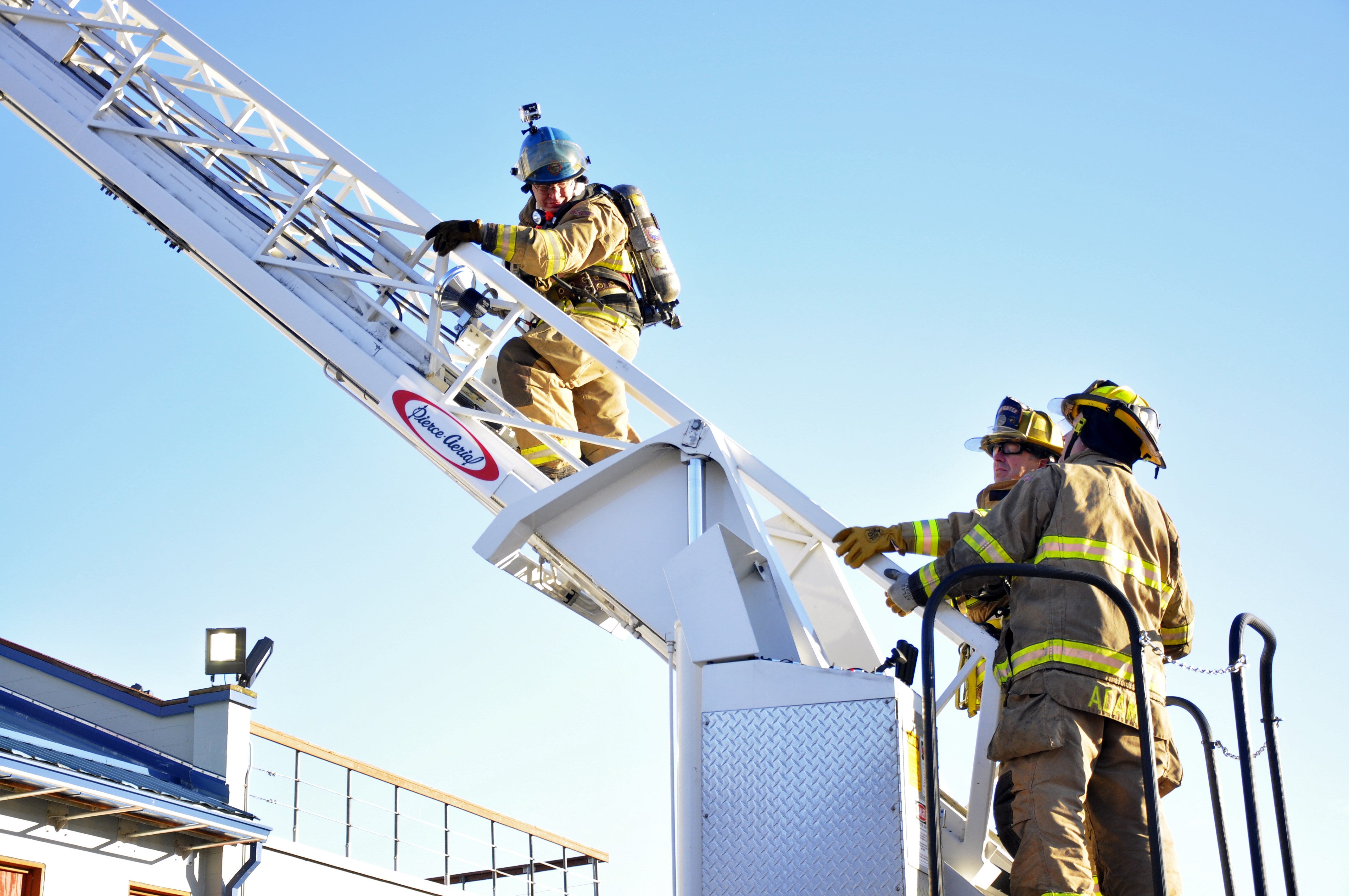 KTOO reporter Matt Miller climbs the ladder during the morning training at Hagevig Fire Training Center. Photo by Annie Bartholomew/KTOO
