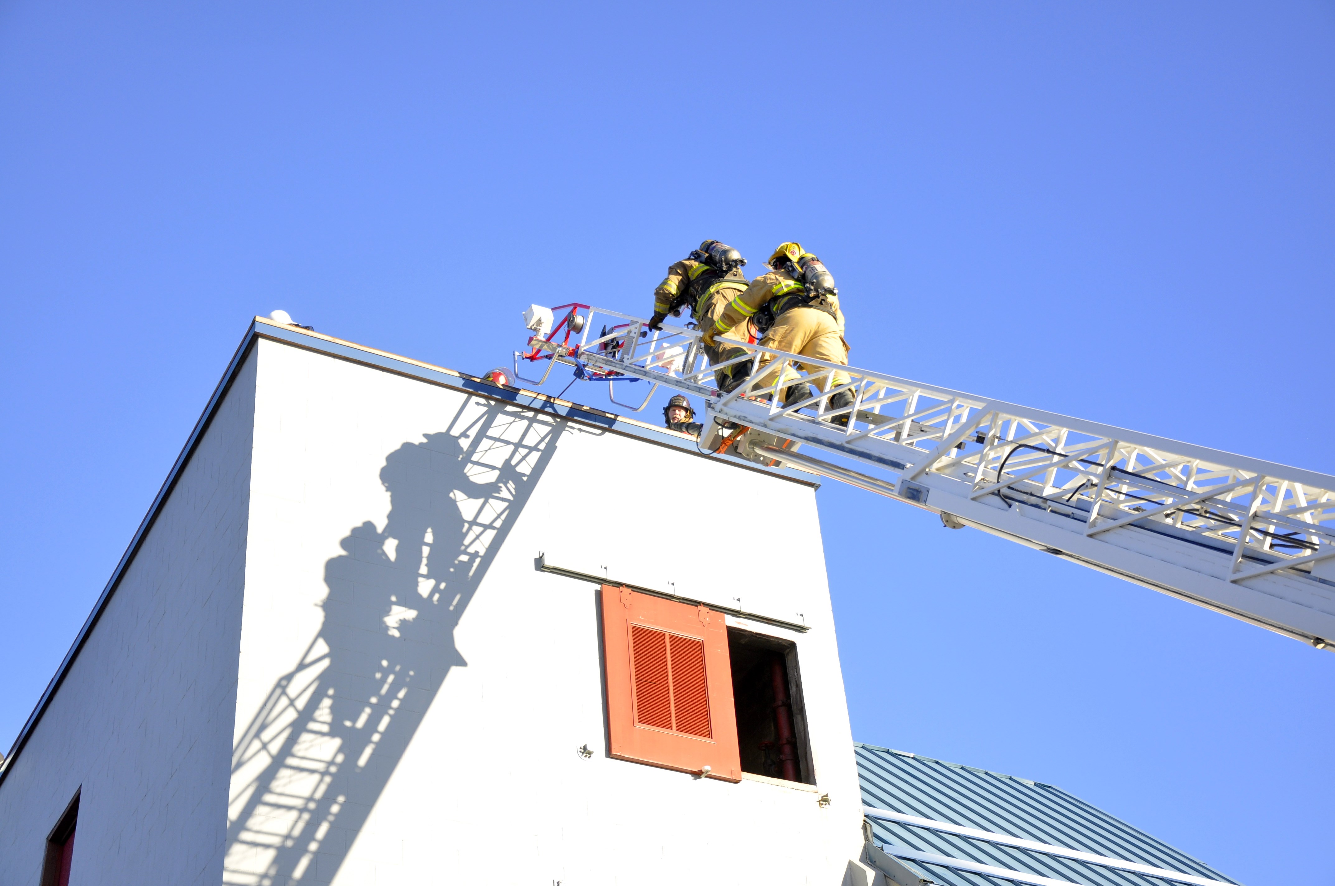 KTOO reporter Matt Miller climbs to the top of the ladder with his "shadow" firefighter Erik Goldsberry. Photo by Annie Bartholomew/KTOO