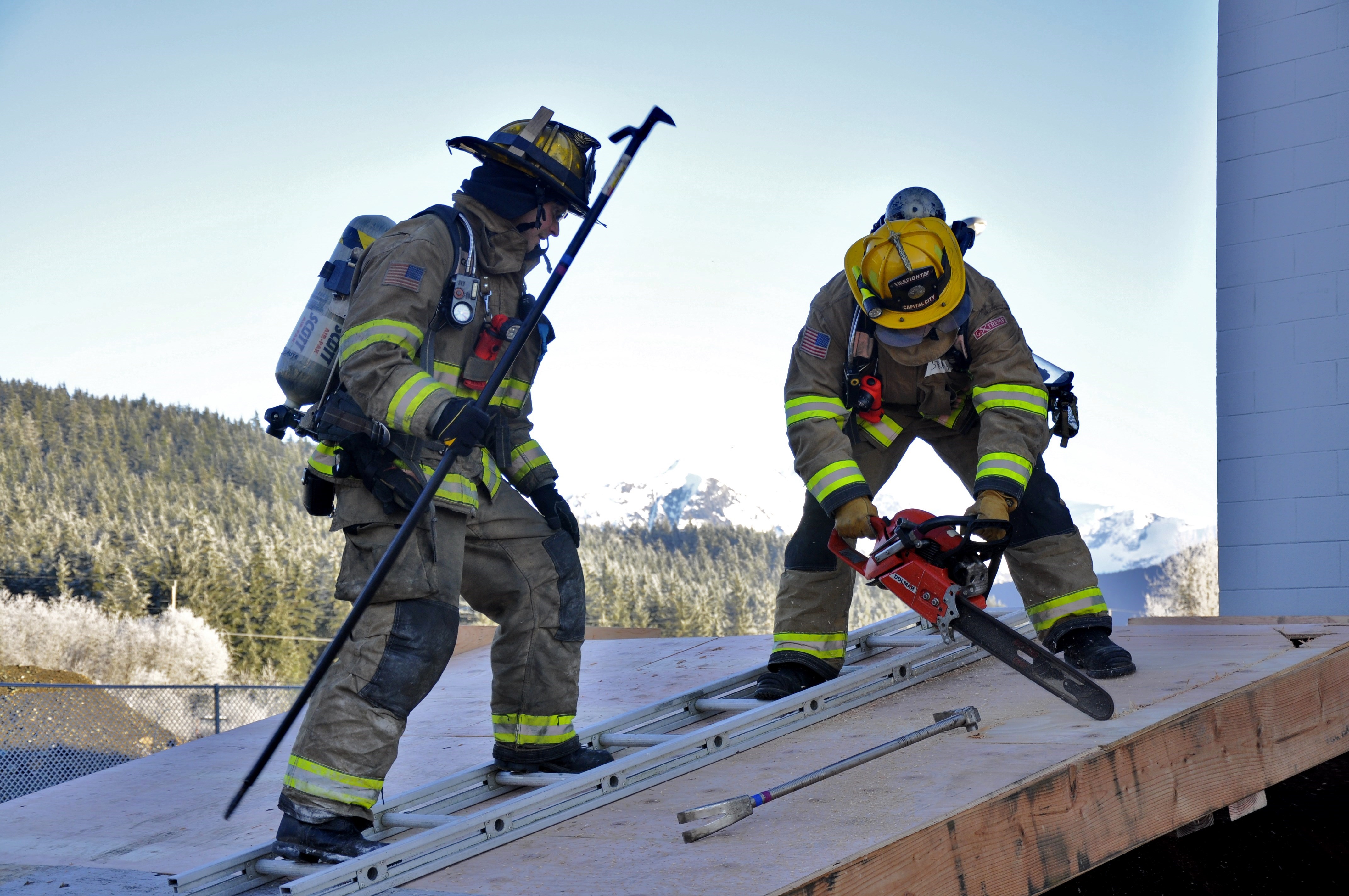 Participants learned how to cut a ventilation hole in a roof using a chainsaw during the training. Photo by Annie Bartholomew/KTOO