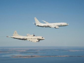 A P-8A Poseidon (top) and a P-3 Orion are shown flying off the coast of Maryland. U.S. Navy