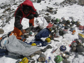 A Nepalese Sherpa collecting garbage, left by climbers, at an altitude of 26,250 feet during a special Everest clean-up expedition. AFP/AFP/Getty Images