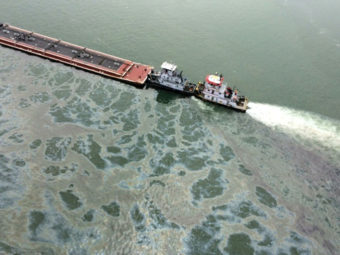 A barge loaded with marine fuel oil sits partially submerged in the Houston Ship Channel on Saturday. PO3 Manda Emery/ASSOCIATED PRESS