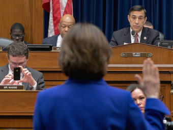 Former IRS official Lois Lerner raises her hand as she's sworn in Wednesday at the start of a House Oversight & Government Reform Committee hearing. She declined to answer questions posed by Chairman Darrell Issa, invoking her Fifth Amendment right. Chip Somodevilla/Getty Images