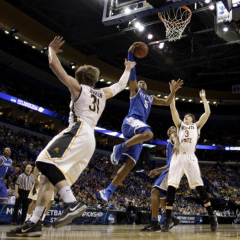 Kentucky's Andrew Harrison goes up for a shot during his team's victory Sunday over Wichita State. The Wildcats' win sent the previously undefeated Shockers home. Charlie Riedel/AP