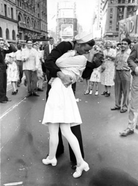 As pedestrians watch, an American sailor passionately kisses a white-uniformed nurse in Times Square to celebrate the long awaited-victory over Japan on August 14, 1945. Alfred Eisenstaedt/Time & Life Pictures/Getty Images