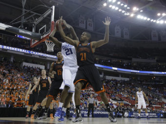Duke forward Amile Jefferson, in white, and Mercer guard Langston Hall battle for the ball during Friday's game. Gerry Broome/AP