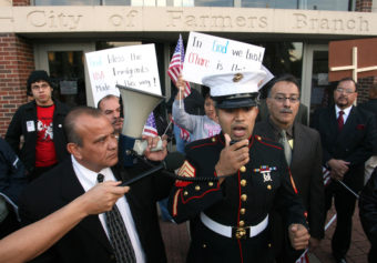 Former Marine Sgt. Salvadaor Parada, right, speaks to protesters during a rally outside city hall in Farmers Branch, Texas in 2006. Rex C. Curry/AP
