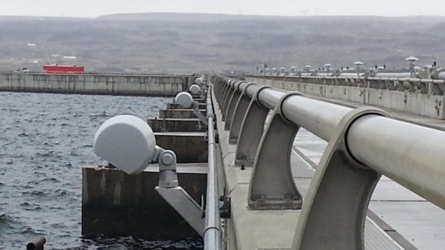A recent photo of the Wanapum Dam shows a slight bend in the conduit below a guardrail along the roadway. A county employee spotted that curve, sparking the discovery of a long crack. Grant PUD