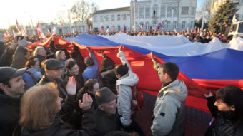 Demonstrators carry a Russian flag during a rally this week in the western Crimean city of Yevpatoria. Genya Savilov /AFP/Getty Images