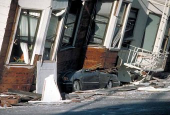 An automobile lies crushed under the third story of this apartment building in San Francisco after the 1989 earthquake. (Photo by J.K. Nakata/U.S. Geological Survey)