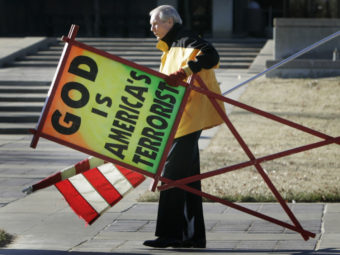 July 2007: The Rev. Fred Phelps Sr. prepares to protest outside the Kansas Statehouse in Topeka, Kan. Orlin Wagner/AP
