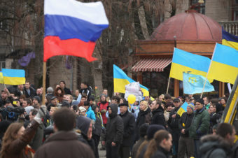 Pro-Russian marchers (foreground) walk past pro-Ukrainian marchers gathered in Simferopol, capital of Ukraine's Crimea region, Saturday. Several hundred pro-Ukrainian protesters marched peacefully through the city center to a Ukrainian military base that's been blockaded by pro-Russian militants and soldiers. Sean Gallup/Getty Images