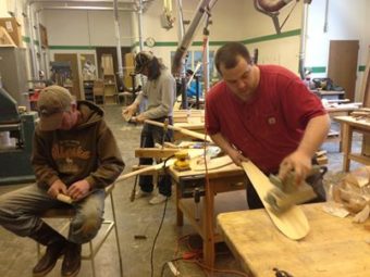 Paddle makers at the One People Canoe Society workshop. (Photo by Shady Grove Oliver/KSTK)