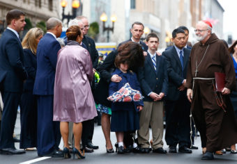One year after the Boston Marathon bombings, families of the victims, including relatives of Martin Richard, attended a wreath-laying ceremony on Boylston Street along with Mayor Martin Walsh (left) and Cardinal Sean Patrick O'Malley (right). Jared Wickerham/Getty Images