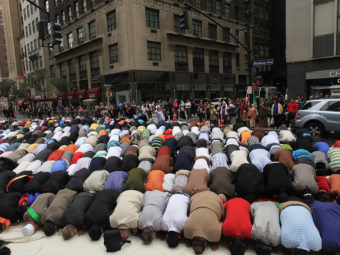 Men pray on the street before the start of the American Muslim Day Parade in 2010 in New York. Spencer Platt/Getty Images